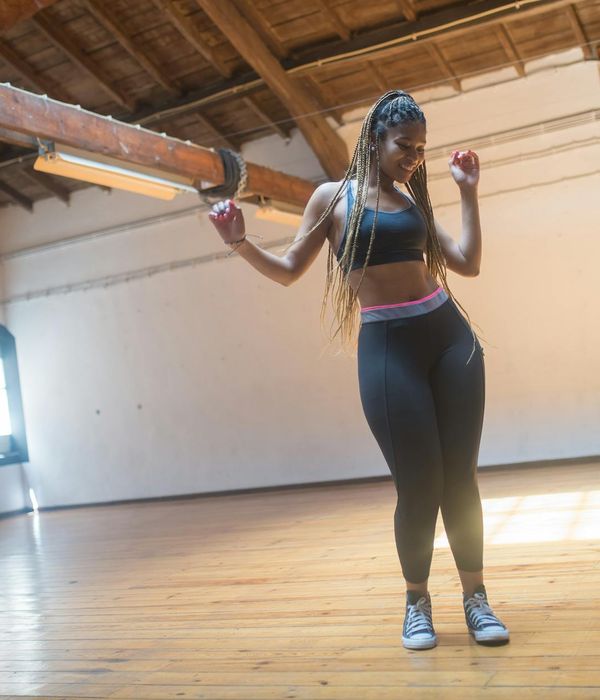 Woman feeling energetic and balanced in a bright, open space.